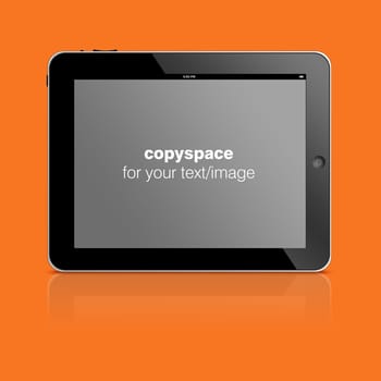 Tablet computer  with copy space to add your text or photo isolated on orange background.