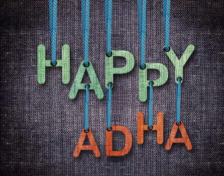 Happy Adha Letters hanging strings with blue sackcloth background.