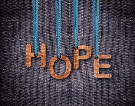 Hope Letters hanging strings with blue sackcloth background.