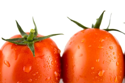 Fresh red tomato with green stem on white background