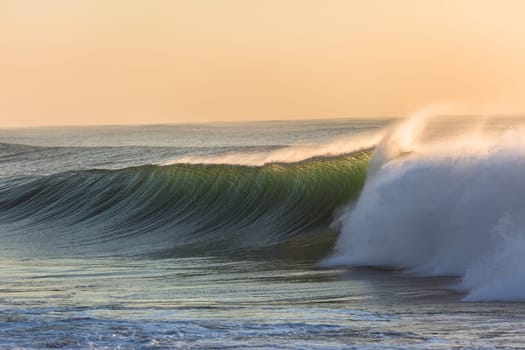 Ocean wave wall from storm swells crashing along shallow beach reef with natures  energy, a swimming photo of sea power.