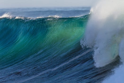 Ocean wave wall from storm swells crashing along shallow beach reef with natures  energy, a swimming photo of sea power.