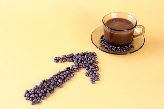 Cup with coffee, costing on coffee grain.