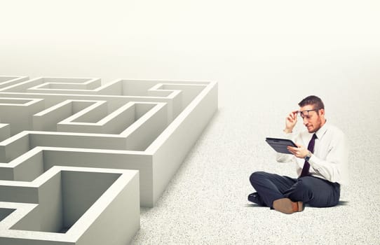 businessman use tablet 3d maze background