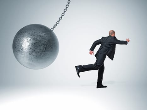 3d image of huge swinging metal ball and businessman