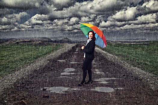 businesswoman with umbrella and rain