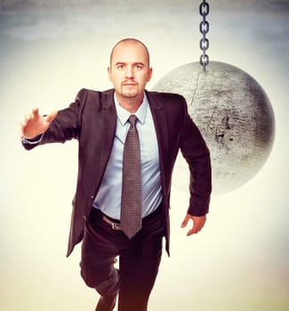 3d image of huge swinging metal ball and businessman