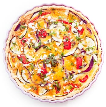 Closeup overhead view of a tasty vegetarian quiche with eggplant or brinjals, cheese, herbs, pepper and tomato in a golden pie crust for a delicious savory meal