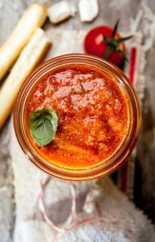 Spicy tomato dip with Italian grissini or crisp bread sticks for a delicious savory appetizer or snack