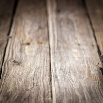 Background of old weathered wooden boards with a diminishing perspective and shallow dof in square format