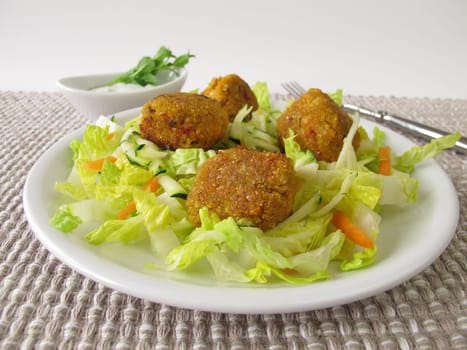 Red lentils balls on salad