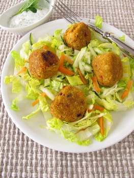 Red lentils balls on salad