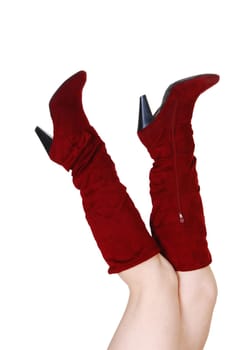 Young woman's legs in red boots, body parts isolated on white.background..