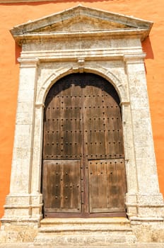 Large wooden door on the front of a church in Cartagena, Colombia