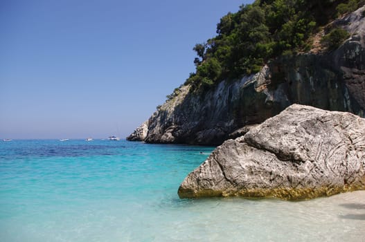 Beach "Cala Goloritze"" in Sardinia. This beautiful bay is located on the eastern coast of Sardinia. It is accessible by boat or on foot via a path through the rugged mountains."