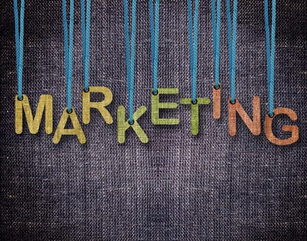 Marketing Letters hanging strings with blue sackcloth background.