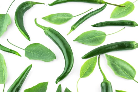 green hot chili pepper with leaves on a white background