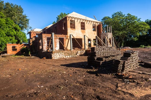 House building construction on open grounds for upstairs downstairs home with hardware raw materials on landscape grounds