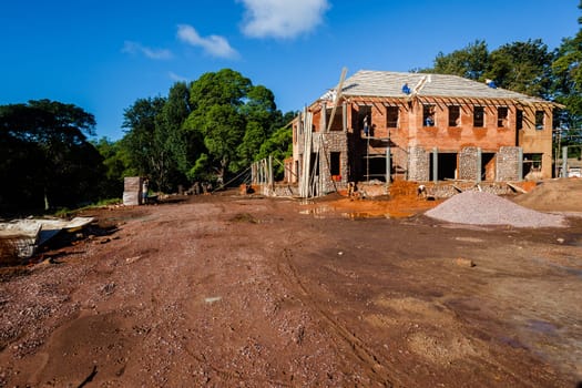 House building construction on open grounds for upstairs downstairs home with hardware raw materials on landscape grounds