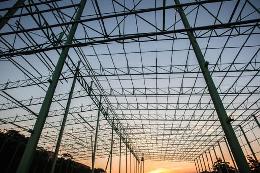 Steel frame warehouse building structure being put together piece by piece