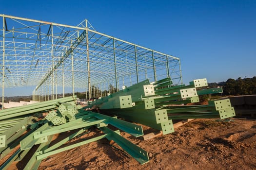 Steel frame warehouse building structure being put together piece by piece