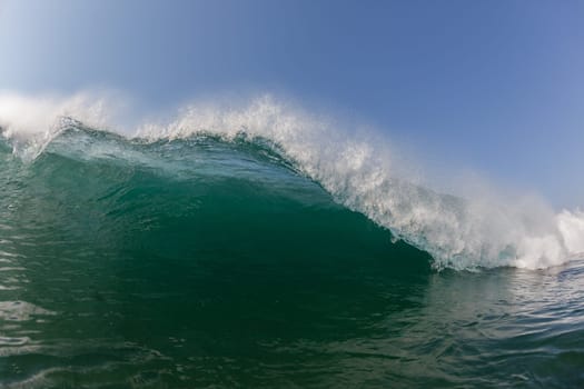 Ocean wave lip water crashing towards shallows with power energy of nature