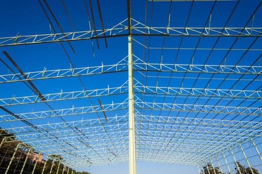 Steel frame warehouse building structure being put together piece by piece