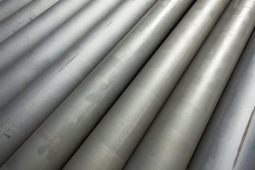 Pipes steel for  water liquid construction stacked together in diagonal closeup photo