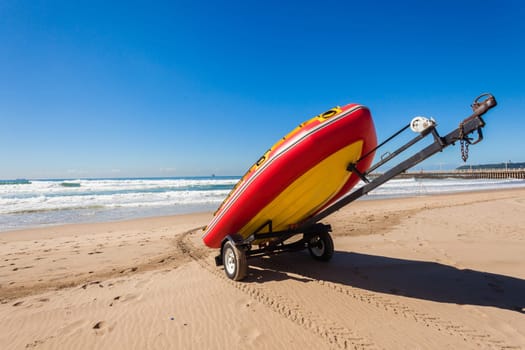 Lifeguard equipment surf rubber boat paddle skis on ocean beach sands for rescue emergancy
