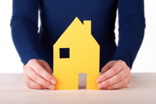 A Woman is Holding a House between her Hands, Isolated