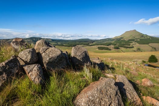Mountain valley rocky trees landscape in summer green blue  sky day in the Southern Drakensberg mountains South-Africa