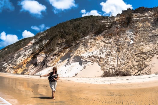 Rainbow beach color sands and rocks alongside ocean sea embankment