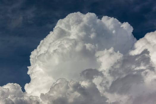 Thick rain clouds in dark blue sky brewing for lightening rain water pouring over the landscape