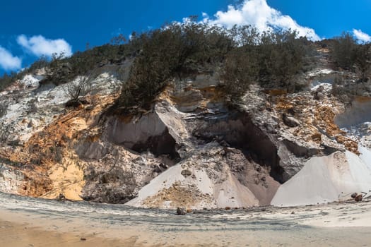 Rainbow beach color sands and rocks alongside ocean sea embankment