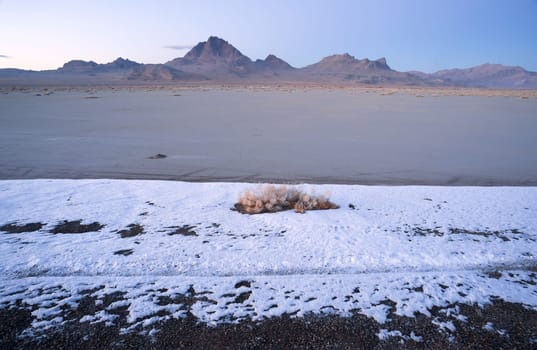 The salt melts the snow first on the flats at sunset