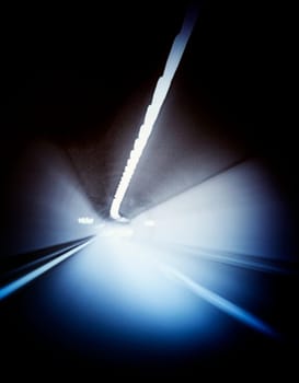 Car lights trails in a tunnel
