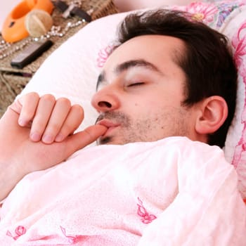 Young man sleeping in bed .