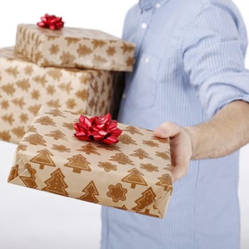 Young man holding a present in hands.