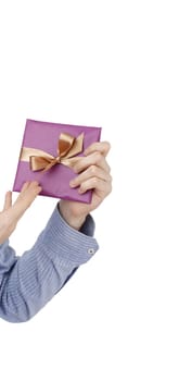 Young man holding a present in hands.