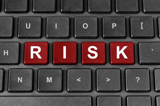 Risk red word on keyboard, business financial concept