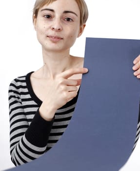 Young blonde woman holding a blank piece of paper.