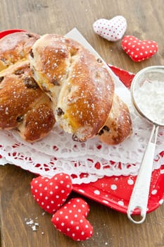 Homemade broetches with raisins on small red tray