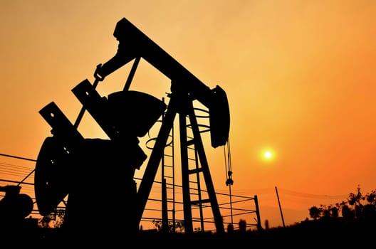 old pumpjack pumping crude oil from oil well