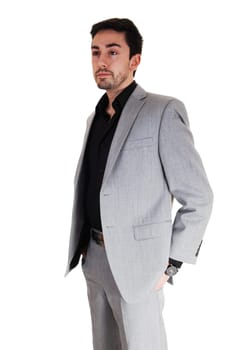 A tall handsome businessman standing isolated for white background .in a grey suit with his hands in his pocket..