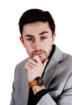 A handsome businessman standing for isolated white background in a .suit with his hand on his chin..
