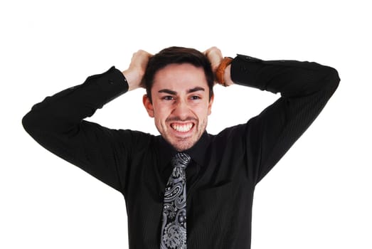 A very angry young man messing his hair standing isolated for white.background..