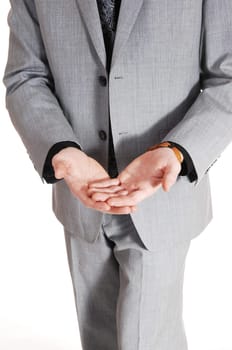 A closeup picture of the front of a man in a grey suit, holding his hands.to get something, isolated for white background..