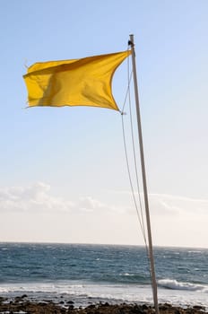 Yellow Festive Flag Waving In The Wind Tenerife Canry Island Spain