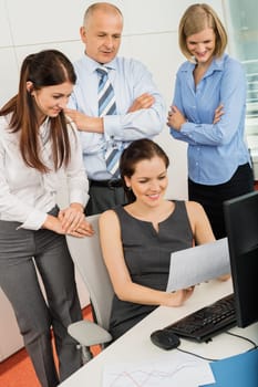 Business colleagues discussing at office desk