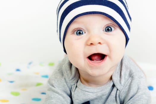 Funny cute blue-eyed baby. Little happy boy